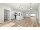 Well-lit living area with wood-look floors, a kitchen island, and stainless steel appliances at 2506 Sw 158Th Lane Rd, Ocala, FL 34473