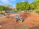 View of the community playground with swings and various playing equipment on a wood chip surface at 2506 Sw 158Th Lane Rd, Ocala, FL 34473