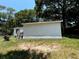 Exterior of home and backyard surrounded by mature trees at 25824 Shawnee St, Sorrento, FL 32776