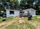 Exterior of home with a wooden porch and a grill at 25824 Shawnee St, Sorrento, FL 32776