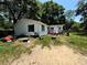 Exterior of home with lawn and mature trees at 25824 Shawnee St, Sorrento, FL 32776