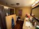 Bathroom featuring granite countertops, dual sinks, and a tiled walk-in shower at 25824 Shawnee St, Sorrento, FL 32776