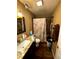 Bathroom with granite vanity, shower, and decorative shower curtain at 25824 Shawnee St, Sorrento, FL 32776