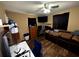 Bedroom with a ceiling fan, wood-look floors, and neutral colored walls at 25824 Shawnee St, Sorrento, FL 32776