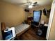 Bedroom with a ceiling fan, wood-look floors, and neutral colored walls at 25824 Shawnee St, Sorrento, FL 32776