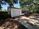 Shot of the home's exterior with a garage and minimal landscaping with fencing in the background at 25824 Shawnee St, Sorrento, FL 32776