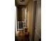 Hallway with hardwood floors and cleaning supplies at 25824 Shawnee St, Sorrento, FL 32776