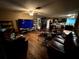 Spacious living room featuring wood floors and a TV at 25824 Shawnee St, Sorrento, FL 32776