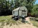 Exterior view of backyard shed and other yard equipment at 25824 Shawnee St, Sorrento, FL 32776