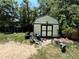 Exterior view of backyard shed and other yard equipment at 25824 Shawnee St, Sorrento, FL 32776