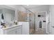 Bathroom featuring a glass shower, vanity, and a door to the laundry room with washer and dryer at 2871 Haze Rd, Clermont, FL 34714
