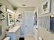 Updated bathroom with glass shelves, sleek vanity, updated lighting, and modern fixtures at 3130 S Bumby Ave # S, Orlando, FL 32806