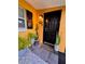Inviting front door with plants and a leopard print doormat for a touch of flair at 3130 S Bumby Ave # S, Orlando, FL 32806