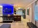 Open-concept living room featuring a dining area, modern lighting, and neutral tile flooring at 3130 S Bumby Ave # S, Orlando, FL 32806