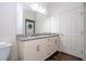Bathroom with a double sink vanity, in-unit washer and drier and a convenient layout at 3229 Cupid Pl, Kissimmee, FL 34747