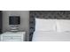 Comfortable bedroom featuring a tufted headboard, a bedside lamp, and a soothing color scheme for a restful atmosphere at 3229 Cupid Pl, Kissimmee, FL 34747