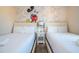 Fun themed bedroom featuring two beds, whimsical decor and soft, neutral colors creating a playful and inviting space at 3229 Cupid Pl, Kissimmee, FL 34747