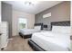 Charming bedroom featuring two beds with plush headboards and soft, neutral decor for a relaxing ambiance at 3229 Cupid Pl, Kissimmee, FL 34747
