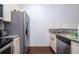 Functional kitchen space featuring stainless steel appliances, granite countertops, and sleek cabinetry at 3229 Cupid Pl, Kissimmee, FL 34747