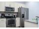 Well-equipped kitchen with stainless steel appliances, granite countertops, and ample storage space for modern convenience at 3229 Cupid Pl, Kissimmee, FL 34747