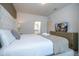Comfortable bedroom featuring a queen bed, stylish decor, and an en-suite bathroom for added convenience at 3229 Cupid Pl, Kissimmee, FL 34747