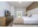 Serene bedroom with a plush bed, modern furnishings, and a window providing natural light and a view at 3229 Cupid Pl, Kissimmee, FL 34747