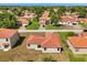 Aerial view of a single-story home with a red tile roof and a well-maintained lawn at 441 Caraway Dr, Kissimmee, FL 34759