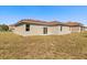 The house has a sliding glass door and a small window looking out to the backyard at 441 Caraway Dr, Kissimmee, FL 34759