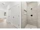 Neutral tiled shower, glass door and adjacent hallway at 441 Caraway Dr, Kissimmee, FL 34759