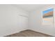 Bedroom with a window and closet space, featuring wood-look flooring and neutral walls at 441 Caraway Dr, Kissimmee, FL 34759