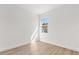 Bright bedroom with wood-look flooring, neutral walls, and a window for natural light at 441 Caraway Dr, Kissimmee, FL 34759