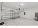 Spacious two-car garage with an automatic door and a clean, concrete floor at 441 Caraway Dr, Kissimmee, FL 34759