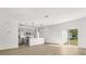 Open floor plan featuring stainless appliances, island kitchen, and wood-look flooring at 441 Caraway Dr, Kissimmee, FL 34759