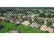 Aerial image showcasing a charming residential neighborhood surrounded by green spaces and mature trees at 453 Sorrento Rd, Kissimmee, FL 34759