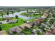 An aerial shot shows residential neighborhood with a scenic lake and lush green landscaping at 453 Sorrento Rd, Kissimmee, FL 34759