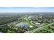 Aerial view of a community featuring lush landscaping, multiple ponds and a meticulously maintained golf course at 453 Sorrento Rd, Kissimmee, FL 34759