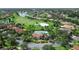 This aerial view shows a community pool, golf course, and surrounding homes at 453 Sorrento Rd, Kissimmee, FL 34759