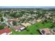 Expansive aerial view of a neighborhood featuring well-maintained lawns and mature trees in a suburban setting at 453 Sorrento Rd, Kissimmee, FL 34759
