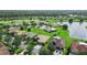 An aerial view highlights a golf course, a lake, and neatly arranged residences in a vibrant community at 453 Sorrento Rd, Kissimmee, FL 34759
