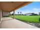 Covered back patio with a view of the lush backyard and nearby homes at 453 Sorrento Rd, Kissimmee, FL 34759