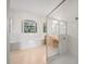 Bright bathroom with a soaking tub, glass-enclosed shower, and tiled floors at 453 Sorrento Rd, Kissimmee, FL 34759