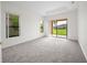 Spacious carpeted bedroom featuring large windows and a sliding door for ample natural light at 453 Sorrento Rd, Kissimmee, FL 34759