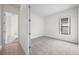An empty bedroom with neutral carpet and a window providing natural light at 453 Sorrento Rd, Kissimmee, FL 34759