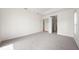 Bright and airy carpeted bedroom featuring a tray ceiling and plenty of natural light at 453 Sorrento Rd, Kissimmee, FL 34759