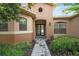 Elegant home featuring a beautiful entryway with stone pathway, lush landscaping, and a welcoming front door at 453 Sorrento Rd, Kissimmee, FL 34759