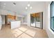 Bright kitchen featuring tile flooring, ample counter space, and sliding glass doors to the outdoor patio at 453 Sorrento Rd, Kissimmee, FL 34759