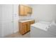 Practical laundry room with wooden cabinets, sink, and modern washer and dryer at 453 Sorrento Rd, Kissimmee, FL 34759