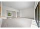 Spacious living room featuring neutral carpet, natural light and open floor plan at 453 Sorrento Rd, Kissimmee, FL 34759
