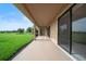 Covered patio with view of spacious green backyard and blue sky, offering a relaxing outdoor space at 453 Sorrento Rd, Kissimmee, FL 34759