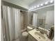 Well-lit bathroom with a shower-tub combo and neutral finishes at 561 Portland Cir, Apopka, FL 32703